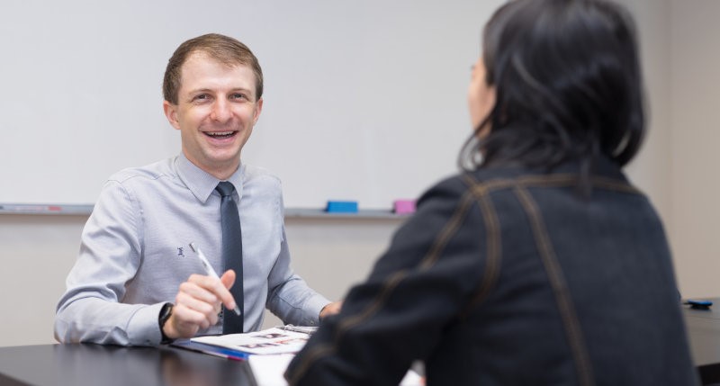 a Modulo French teacher laughing with a student